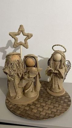 two nativity figurines sitting on top of a table