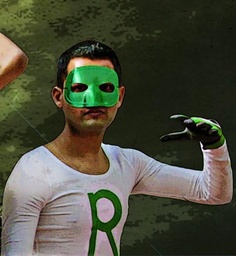 a man wearing a green mask and holding a string with his hands in the air