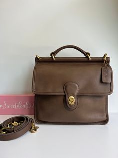 Vtg Coach Original  Willis Satchel Classic style and built to last! Beautiful soft supple leather with brass hardware. Top handle  Features: -2 roomy areas, inner zip pocket covered by a flap and secured with a turnlock -large back slip pocket -Adjustable, detachable 42" Strap Measures: 10 1/2"L, 10"H, 3"W Hang tag and chain Made in the United States #H5C-9927 Cleaned, conditioned and ready to wear! Flaws: straps have 3 additional holes Questions? Just Ask More vtg coach colors/styles available Classic Leather Bag With Cc Turnlock Closure, Leather Satchel With Cc Turnlock Closure, Classic Everyday Briefcase With Brass Hardware, Classic Briefcase With Brass Hardware For Everyday, Leather Satchel With Cc Turnlock For Office, Top Handle Satchel With Cc Turnlock Closure For Travel, Top Handle Satchel With Cc Turnlock For Travel, Leather Satchel With Cc Turnlock For Work, Brown Leather Satchel With Turn-lock Closure