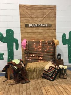 the barn dance stage is set up with hay and saddles for horses to ride