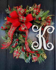 a christmas wreath with the letter k on it