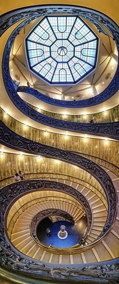 a spiral staircase in a building with a skylight on the top and below it