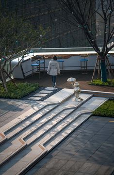 a woman is walking down some steps in the evening