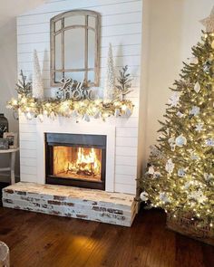 a living room decorated for christmas with a fire place and decorations on the mantel