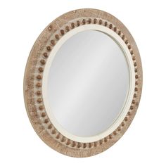 a round mirror with beaded trim around the edges and an oval frame, on a white background