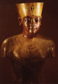 an ancient egyptian statue with a gold crown on it's head