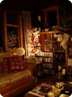 a living room filled with furniture and a christmas tree