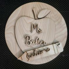 an apple shaped wooden plaque with the words mr and baker welcome on it's side