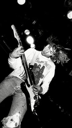 black and white photograph of a man playing guitar