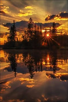 an airplane is flying over the water at sunset