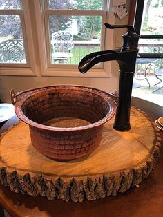 a sink that is sitting on top of a tree stump