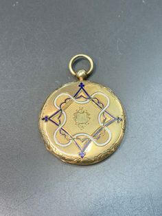 Measurement: 5.5 cm by 4.5 cm by 0.7 cm Metal: 14k Gold Weight: 16.7 Grams *Some enamel missing on not sides of locket Blue Enamel Locket Jewelry, Luxury Blue Locket Jewelry, Formal Blue Inlay Jewelry, Blue Hallmarked Medallion Jewelry, Blue Engraved Jewelry For Keepsake, Formal Enamel Locket Jewelry, Traditional Yellow Gold Keepsake Jewelry, Traditional Yellow Gold Jewelry For Keepsake, Luxury Blue Medallion Jewelry