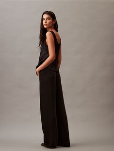 Styled in a wide leg silhouette, these pants feature a gentle drape and a relaxed, effortless fit. Created with an elastic waist that pulls-on for easy wear. Crafted from a recycled polyester blend for reduced environmental impact.  Material: 50% Recycled Polyester, 50% Polyester. Calvin Klein Elegant Wide Leg Bottoms, Chic Wide Leg Calvin Klein Pants, Black Viscose Wide Leg Pants, Calvin Klein Wide Leg Cotton Bottoms, Black Pull-on Wide Leg Pants, Environmental Impact, Easy Wear, Leg Pants, Wide Leg Pants