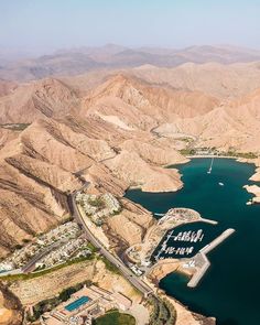 an aerial view of a lake surrounded by mountains