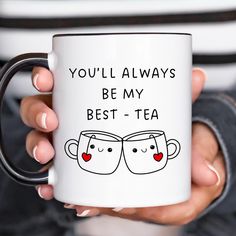 a woman holding a coffee mug that says you'll always be my best - tea