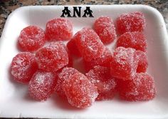 a white plate topped with lots of sugar covered candies on top of a counter