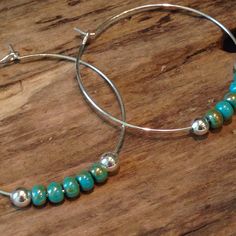 These beautiful hoop earrings are made with lead free silver hoops measuring 1 1/2 inches. Gorgeous turquoise picasso beads are added with round silver 6mm beads on each end. Perfect size with that classic Boho style! Perfect go to earrings for work or play! Your beautiful earrings will come packaged in a pretty gift box, perfect for gift giving or keeping! Nickel-free Silver Beaded Hoop Earrings, Hoop Silver Bead Jewelry Gift, Hoop Silver Beads Jewelry Gift, Silver Beaded Hoop Earrings As Gift, Silver Beads Hoop Jewelry For Gift, Silver Bohemian Hoop Earrings With Round Beads, Nickel Free Silver Small Hoop Beaded Earrings, Nickel-free Silver Small Hoop Beaded Earrings, Turquoise Dangle Hoop Earrings Nickel Free