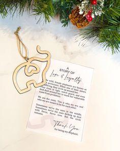 an ornament hanging from a christmas tree next to a note that says, a story of love and a happy life