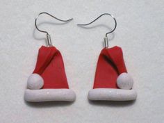 pair of red and white santa hat earrings with silver earwires on white background