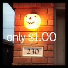 a sign that is on the side of a building with a jack - o'- lantern