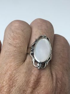 Lovely polished sterling silver has the look of Deco with a huge white Mother Of Pearl set in very detailed vintage filigree Size 7.75 We can size these with an additional $10-$20 fee for the jeweler All rings are shipped in a nice gift box. Check out our over a THOUSAND great reviews Engraving is $4 per letter and is not always perfect depending on the piece. It can take a few days if the jeweler is busy. This is payable to Paypal Judithsltd@gmail.com Antique Silver Oval Filigree Ring, Hallmarked Silver Oval Filigree Ring, Hallmarked Silver Filigree Ring In Oval Shape, Classic Silver Filigree Ring Collectible, Vintage White Rings With Polished Finish, Victorian White Sterling Silver Jewelry, Victorian Style White Sterling Silver Jewelry, White Cabochon Jewelry For Formal Occasions, Vintage White Cabochon Jewelry