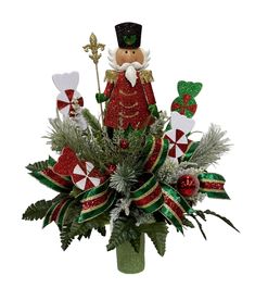 a vase filled with green and red decorations