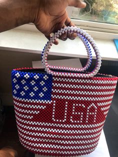 Plastic beaded American flag bag with an inner zipper capable of carrying anumber of stuff Paper Bead Bracelet, Flag Bag, Paper Beads Necklace, Bead Bag, Beaded Shoes, Plastic Mesh, Beaded Earrings Diy, Traditional Outfit, Beaded Cuff Bracelet