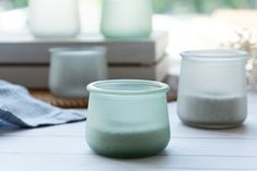 three glass jars sitting on top of a table