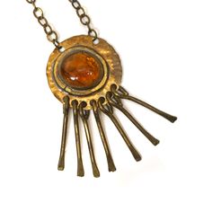 "A hand crafted modernist necklace in brass with dangle decor and glass pendant by Rafael Alfandary. Some tarnishing to chain. Signed on back on pendant. Length (pendant): 3\" Width (pendant): 1-1/2 Length (chain): 16\"" Retro Brass Dangle Jewelry, Retro Brass Pendant Jewelry, Retro Adjustable Brass Jewelry, Adjustable Retro Brass Jewelry, Antique Gold Cabochon Brass Necklace, Antique Gold Brass Necklace With Cabochon, Retro Soldered Metal Jewelry, Vintage Hand Forged Metal Necklace, Vintage Hand Forged Brass Jewelry