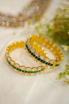 22k gold plated bangles with clear and emerald moissanite polki stone studded patterns. - Aza Fashions Jewellery Bangles, Gold Plated Bangles, Stone Studs, Bangle Set, 22k Gold, Aza Fashion, Jaipur, Emerald Green, Emerald