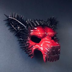 This red/black masquerade mask embodies the untamed spirit of the wolf, making you a fierce and magnetic presence at themed events, masquerades, or Halloween parties. The silver spikes bring an element of power and ferocity to the mask, setting you apart as an undeniable force. Age Group/Gender - Adult/Men Size/Type - One size fits all adults Mask Color - Red/Black Mask Material - Polyresin Accent Material - Paint Special Features - Black spikes Punk Masks For Costume Party And Cosplay Events, Punk Style Masks For Costume Party And Cosplay Events, Gothic Masks For Party And Cosplay Events, Punk Halloween Cosplay Masks, Gothic Halloween Masks, Gothic Masks And Prosthetics For Masquerade And Cosplay, Black Fantasy Masquerade Mask For Cosplay, Gothic Masks For Halloween Fantasy Events, Gothic Masks For Halloween