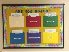 a bulletin board with different colored folders on it and the words are you bored?