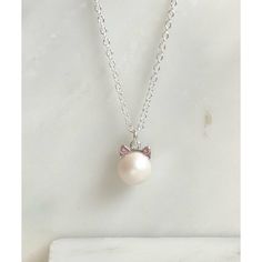 This adorable necklace is made with a SWAROVSKI® 8mm pearl charm with cat ear caps. The pearl is white with a hint of iridescent shine and has little pointed ears that have matching pink crystals. The charm hangs from an 18" silver-filled necklace in your choice of length. White Pearl Charm Necklace For Birthday, White Necklace With Pearl Charm For Birthday, White Pearl Charm Necklace With Pearl Drop, White Pearl Drop Charm Necklace, White Sterling Silver Charm Necklaces With Pearl Chain, White Pearl Pendant Necklace For Birthday, White Pearl Pendant Necklace For Birthdays, Cute Pearl Charm Jewelry, Cute Pearl Jewelry With Pearl Charm