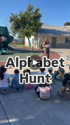 children sitting on the ground in front of a playground with text overlay reading alphabet hunt