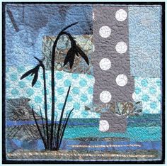 a patchwork quilt with an image of a palm tree and the ocean in the background