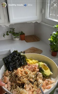 a person holding a bowl full of food