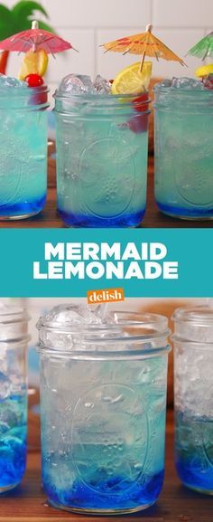 several jars filled with blue liquid and lemon slices