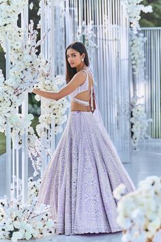 This lehenga set features pearl, sequin & crystal embroidery on a lavender net base. The skirt is paired with fully embellished blouse with dual strings at the back and a matching scalloped net dupatta.From Seema Gujral's Tuscan Summer collection. DELIVERY TIMEPlease allow 8-12 weeks for your outfit to arrive. FABRIC DETAILSNet Professional cleaning only. Lavender Sharara With Intricate Embroidery For Wedding, Lavender Embroidered Sharara For Wedding, Lavender Wedding Set With Sheer Dupatta, Lavender Lehenga With Mirror Work For Party, Party Lehenga With Mirror Work In Lavender, Lavender Sharara With Sheer Dupatta For Wedding, Bollywood Lavender Lehenga For Party, Party Lavender Lehenga With Mirror Work, Bollywood Style Lavender Lehenga For Party