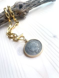 The same beautiful coin medallion as seen in the Gloria Necklace but with a heavier brass chunky chain. Necklace closes with hammered gold over brass toggle clasp. Chain measures 18.5 inches in length, pendant adds additional 2.5 inches. Wear this with anything. Coin details may vary slightly. All jewelry items are delivered to you wrapped perfect for gift giving! Gold-tone Medallion Necklace With Coin Pendant, Nickel-free Yellow Gold Medallion Coin Necklace, Gold Medallion Necklace With Lobster Clasp, Engraved Brass Medallion Coin Necklace, Gold-tone Medallion Brass Chain Necklace, Gold-tone Brass Medallion Chain Necklace, Brass Coin Necklace With Large Pendant, Brass Coin Shaped Necklace With Large Pendant, Vintage Medallion Coin Necklace With Large Pendant