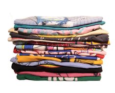 a stack of t - shirts sitting on top of each other