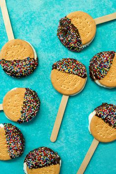 chocolate covered cookies and sprinkles on wooden sticks