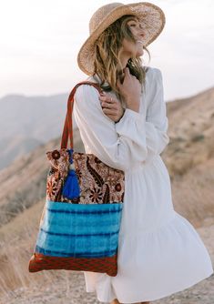 A show-stopping statement bag inspired by some of our favorite vintage designs. Our tie dye patchwork tote bag features a large tassel accent and a snap closure. FINAL SALE Mixed media patchwork Tie-dye Paisley Snap closure Large tassel accent Dimensions: 15" x 20"Style: DR-2105-2 Everyday Bohemian Cotton Hobo Bag, Bohemian Patchwork Cotton Shoulder Bag, Bohemian Cotton Patchwork Shoulder Bag, Hippie Tote Bag For Daily Use, Hippie Cotton Shoulder Bag For Travel, Bohemian Patchwork Bags For Summer, Bohemian Cotton Shoulder Bag For Travel, Summer Travel Shoulder Bag With Patchwork, Bohemian Cotton Canvas Shoulder Bag