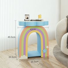 a child's table with a rainbow painted on it and measurements for the height