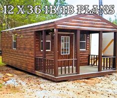 a small wooden cabin sitting on top of a dirt field