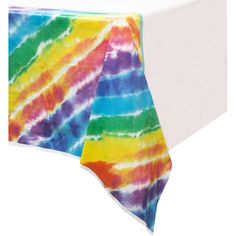 a tie - dyed table cloth is on top of a white table