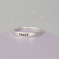 "♥ Also known as stackable mothers rings, these stacking name rings are great ways to wear children's names. ♥ The ring is made from solid .925 Sterling silver. You can choose to plate (coat) the items with yellow gold or rose gold, free of charge. ♥ By default, silver rings come with black engraving and gold rings come with clear engraving. --HOW TO ORDER AND SEND US INSTRUCTION FOR PERSONALIZATION-- - Select the color and size you would like at the drop down options. - Include in the \"Add you Ring With Name, Mothers Ring Stackable, Mothers Rings, Name Ring, Engraved Ring, Mother Rings, Bar Ring, Name Rings, Stacking Ring Set