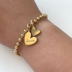 Our adorable heart design is simple but stunning. Totally darling with no engraving or personalize with your favorite human or doggos name. This is your party and you can engrave what you want to!

Bracelet: 3mm beads | Heart Tag: 15mm | Chain: 6.75" + 1" Extension
Add more personalized heart charm here. Gold Name Bracelet With Heart Beads For Friendship, Personalized Heart Bracelet With Round Beads For Mother's Day, Personalized Heart Bracelet With Round Beads For Valentine's Day, Personalized Heart Beads Bracelet, Mother's Day Heart Bracelet With Round Beads, Valentine's Day Friendship Name Bracelet With Heart Charm, Personalized Charm Bracelet With Round Beads For Valentine's Day, Valentine's Day Personalized Charm Bracelet With Round Beads, Personalized Charm Bracelet For Valentine's Day