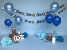 a cake table with cookies and balloons on it