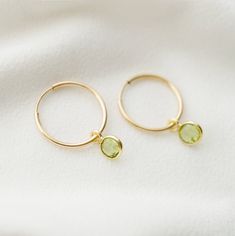 Dainty 14K gold-fill hoop earrings with sparkly suspended peridot stones, are the perfect finish to a stylish outfit. *Free shipping for orders to USA and Canada, and no duties and customs fees.* > 14K gold fill hoops are 16mm in diameter > 14K gold fill hoops, and gold vermeil frames around the stones > Two earrings in one: easily remove the gemstones if you wish to wear simple gold hoops > Our gemstones are natural and individual. Some may show natural inclusions and irregularities Minimalist 14k Gold Filled Green Earrings, Dainty May Birthstone Hoop Earrings, Gold Hoop Earrings With Birthstone For Everyday, Minimalist Gold Hoop Earrings With Birthstone, Simple Gold Hoops, Gold Filled Hoops, Peridot Stone, Vermeil Jewelry, Stylish Outfit