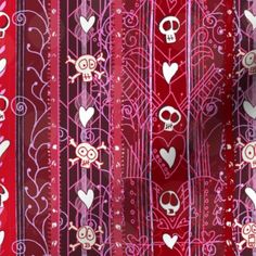 red and pink fabric with skulls, hearts and swirls on the bottom half of it